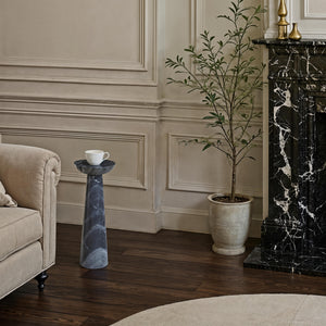 Mercura side table in a classic interior, holding a coffee cup near a decorative plant.