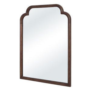 Octavian mirror angled view showcasing a brown wood frame and arched top.