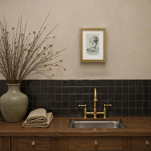Bellie wall art displayed in a bathroom setting, framed in gold above a wooden sink.