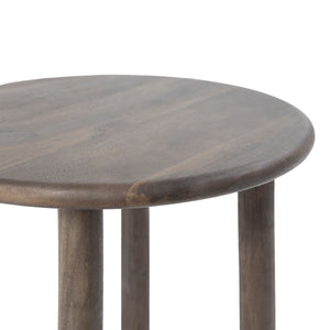 Close-up of Cetus accent table showing the round top and textured surface in dark wood.