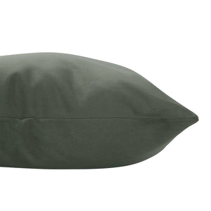 Philemon indoor pillow in dark green, angled side view highlighting tapered edge.