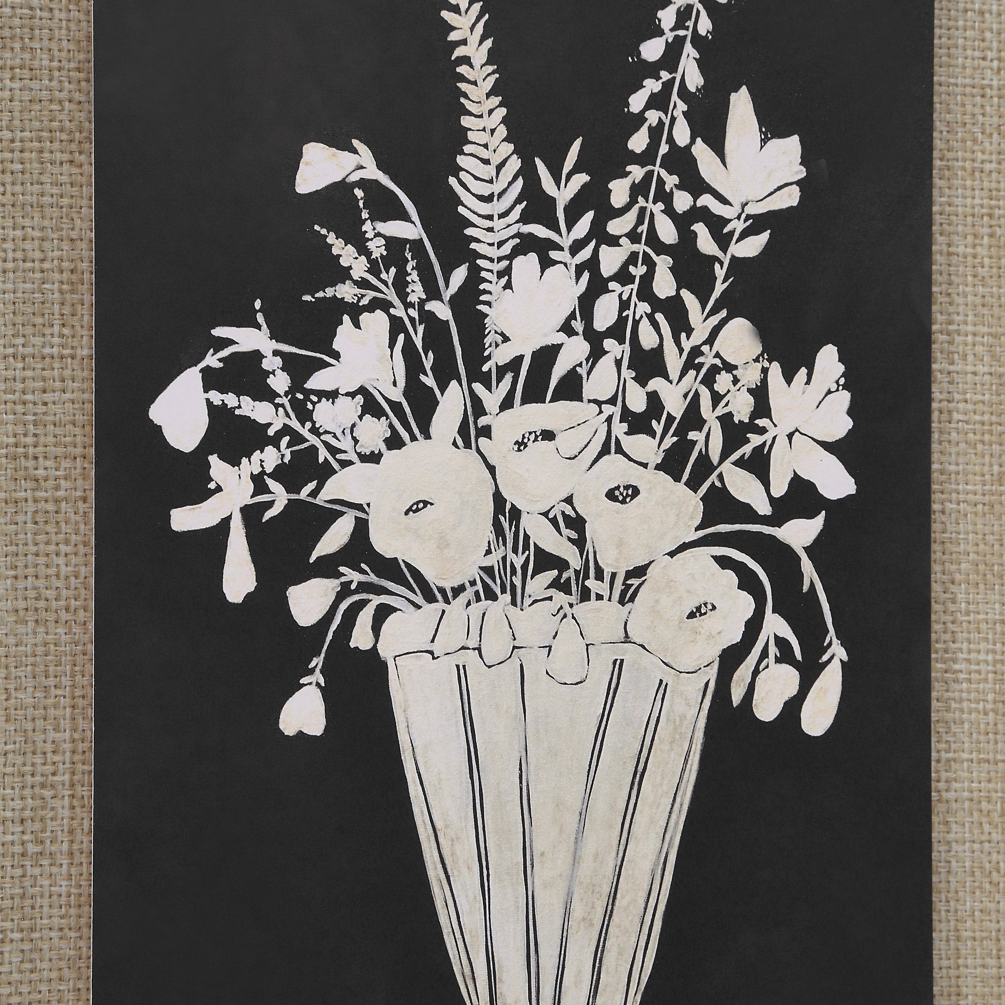 Tecoma canvas art close-up of a white floral design in a striped vase against a black surface.