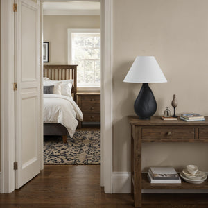 Sotiria Table Lamp on a wooden console in a cozy bedroom setting