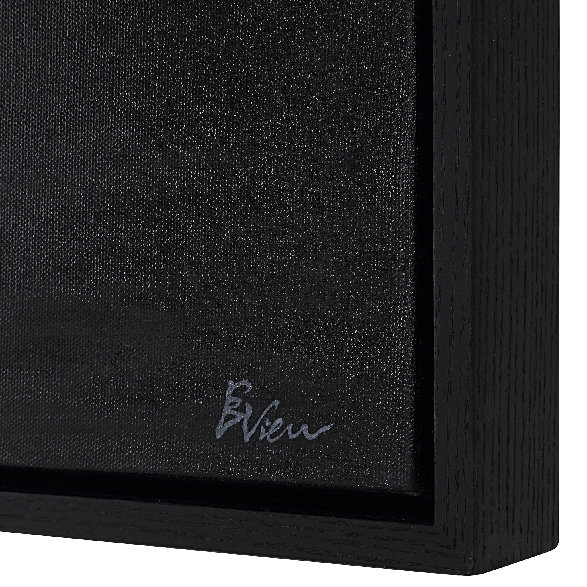 Suez canvas art featuring a textured black surface with a black wooden frame and signature detail.