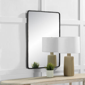 Jorah Wall Mirror displayed above a console table with a lamp and plant.