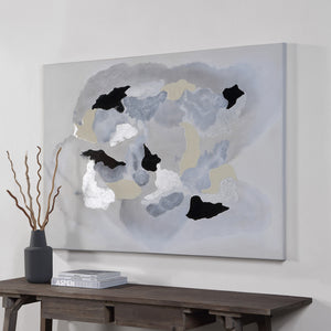Alasia canvas art featuring abstract shapes in gray, black, and metallic silver on a light background, displayed on a wall.