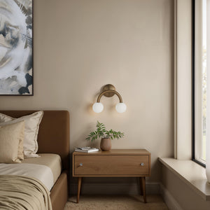 Santi wall sconce in a cozy bedroom with a wooden nightstand and plant