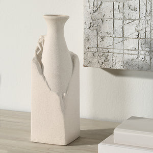 Adonia Vase by Renwil displayed on a table next to a textured wall art piece