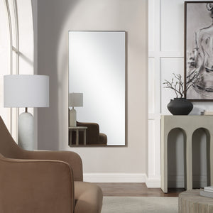 Orrin mirror by Renwil, displayed in a modern living room setting with a lamp and decor.
