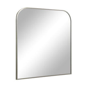Salma mirror featuring a rounded top, angled view showing the silver frame and reflective surface
