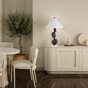 Elle table lamp on a modern cabinet beside a potted tree in a stylish interior.