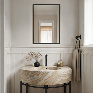 Elvas mirror with a sleek black frame above a stylish marble sink with beige and cream swirls in a modern bathroom setting.