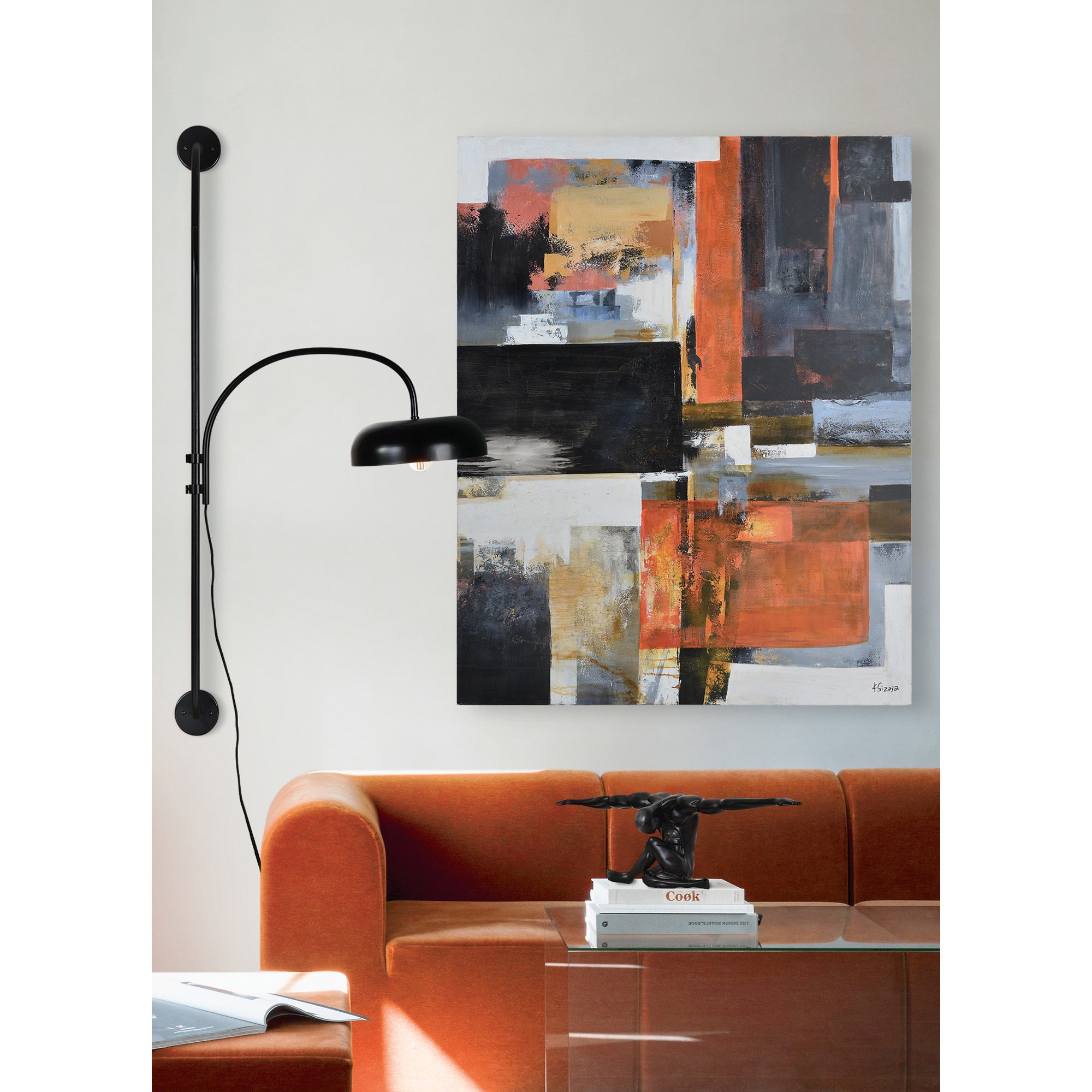 Draco Wall Sconce in a modern living room setting, next to an abstract painting.