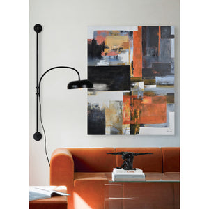 Draco Wall Sconce in a modern living room setting, next to an abstract painting.