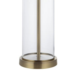 Close-up of Saco Table Lamp featuring a clear glass base and brass accents