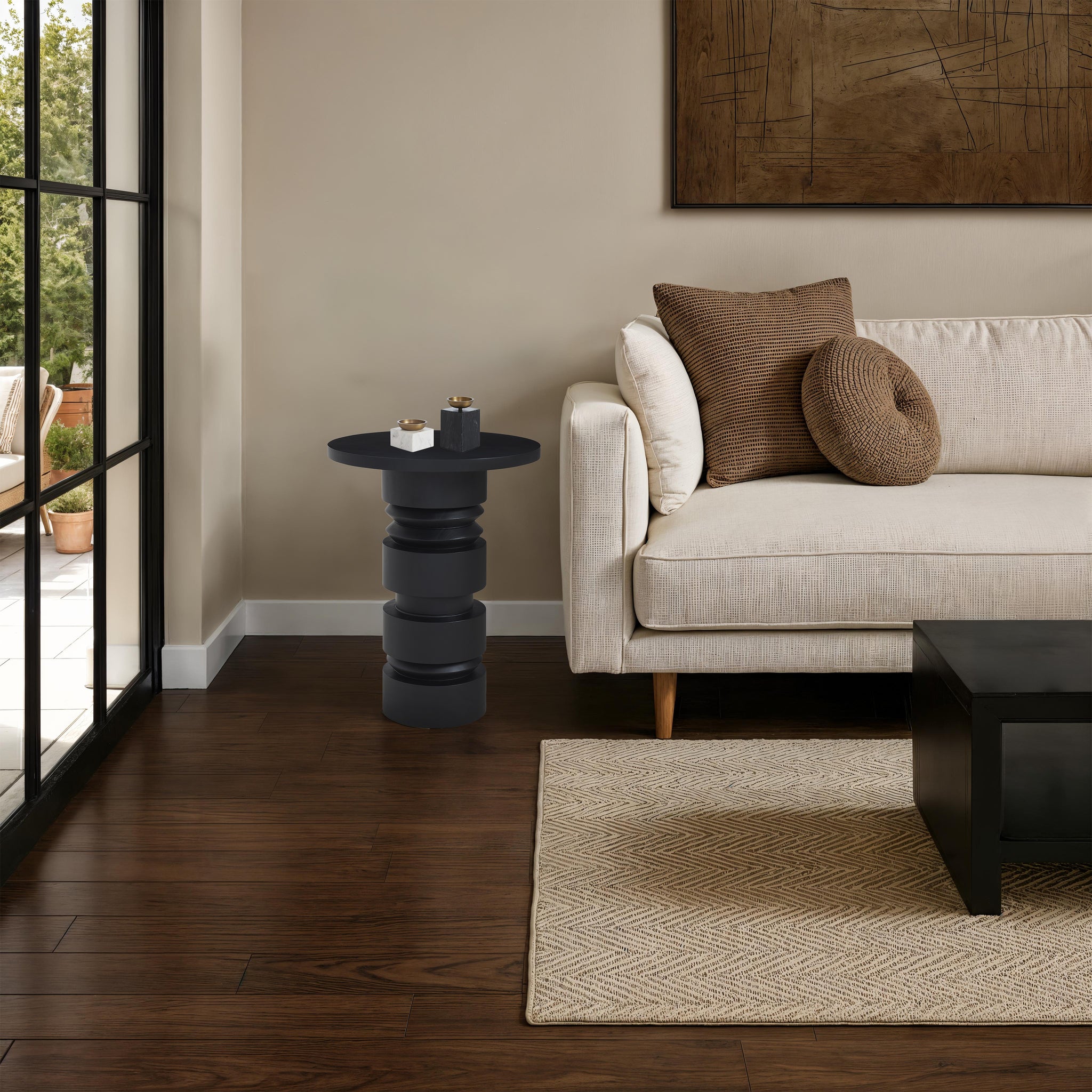 Talpa end table beside a beige sofa, decorated with candles and a cozy atmosphere.