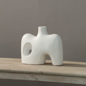 Mariner Vase displayed on a wooden table, showcasing its sculptural form in white.