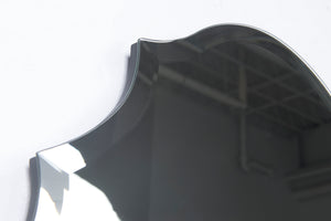 Close-up of Emma mirror by Renwil, showcasing scalloped edges and reflective surface.