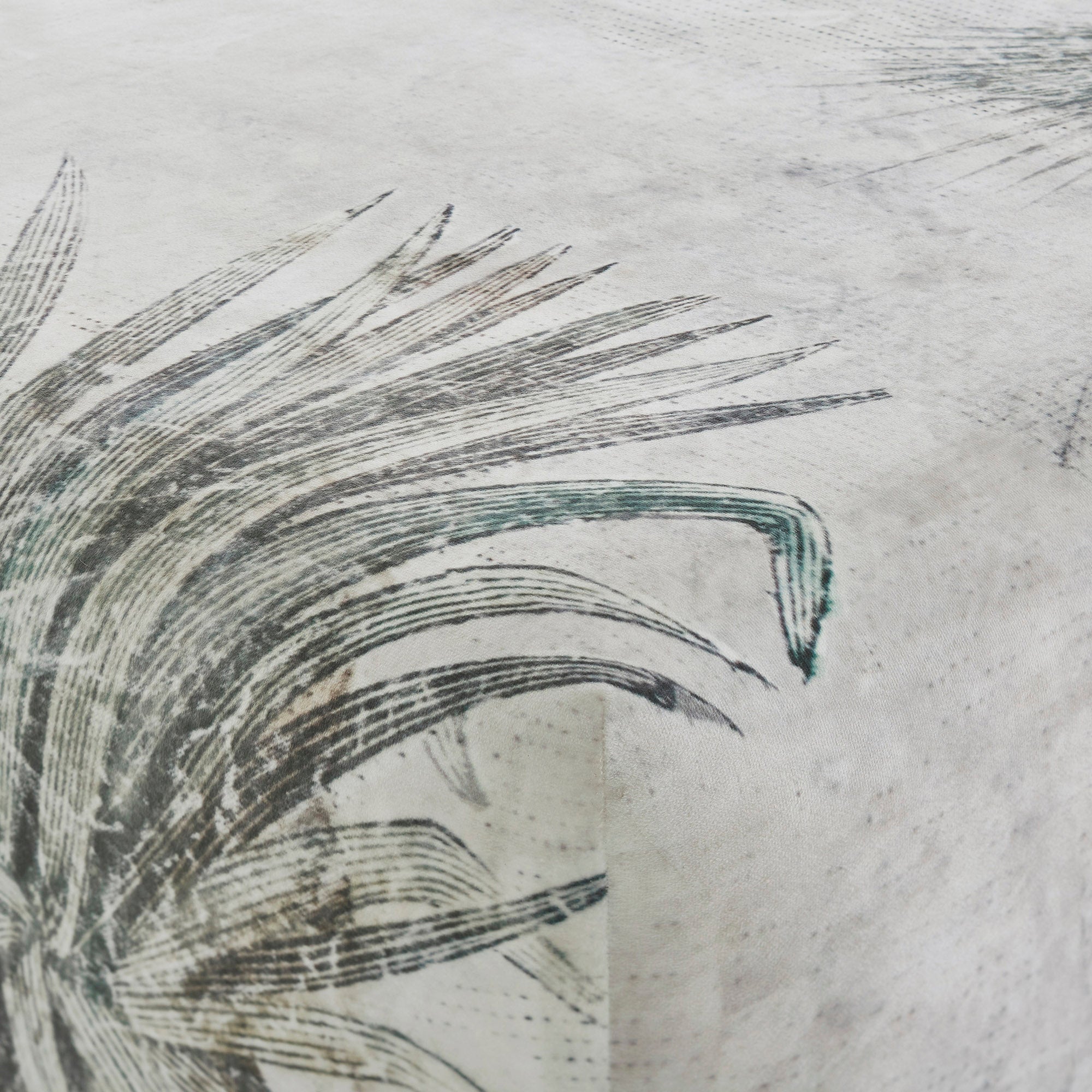 Close-up of Tangle Ottoman's botanical print fabric, showcasing intricate leaf details.