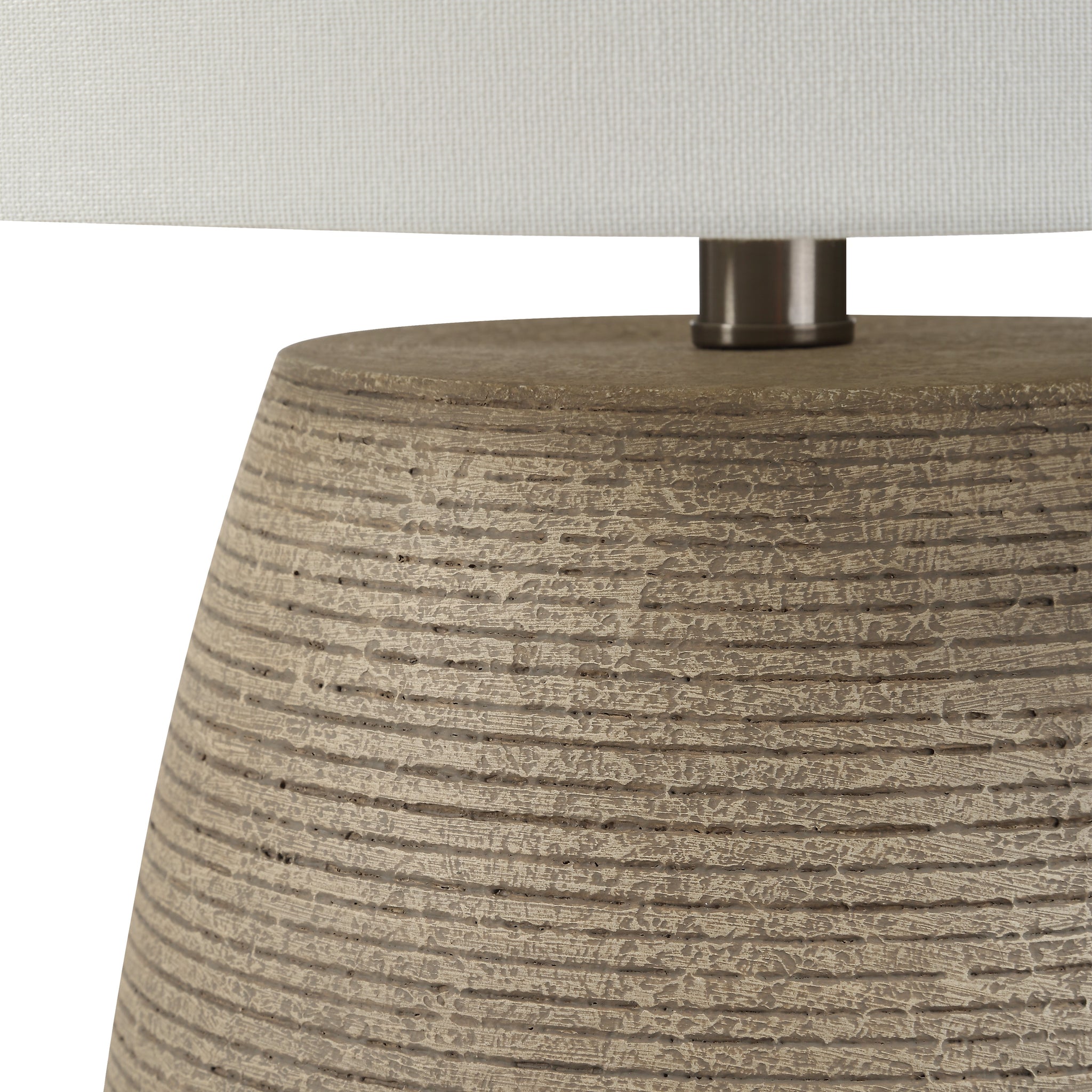 Close-up of Optima table lamp showcasing the beige textured base and white shade.