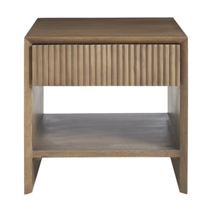 Jaime side table with a ribbed drawer front and open shelf, made of light wood.