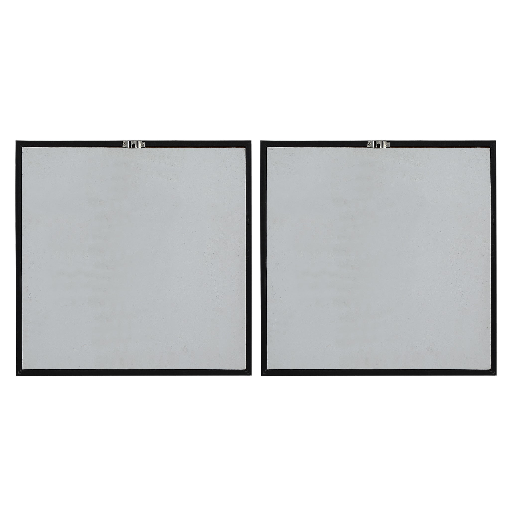 Back view of two framed abstract paintings, showing the black frames.