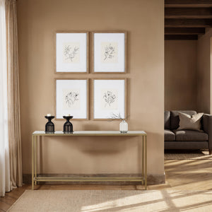 Bodin Console Table styled with black candle holders and framed art on a beige wall