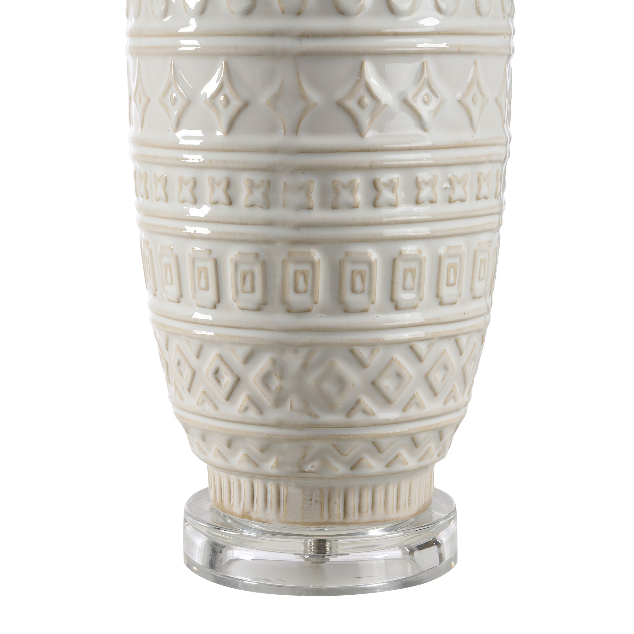 Close-up of Sereno Table Lamp's white ceramic base featuring intricate patterns.