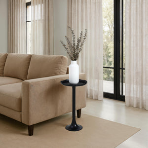Fiora side table beside a beige sofa, adorned with a white vase and greenery.
