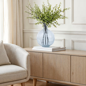 Mirabella vase by Renwil, styled with green branches, placed on a wooden cabinet
