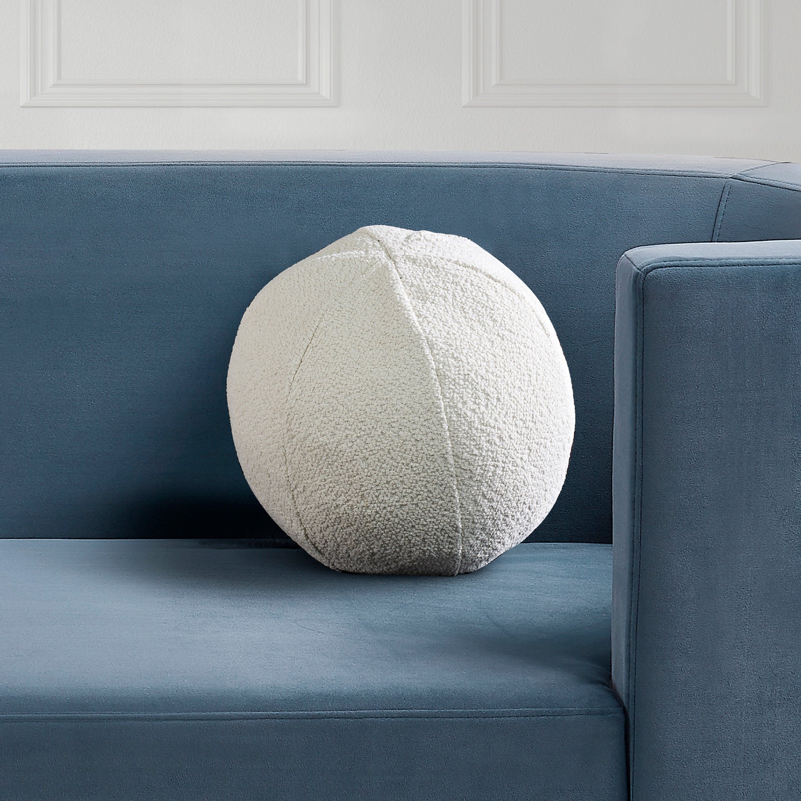 Solan Indoor Pillow in cream color, textured fabric, round shape, top view.