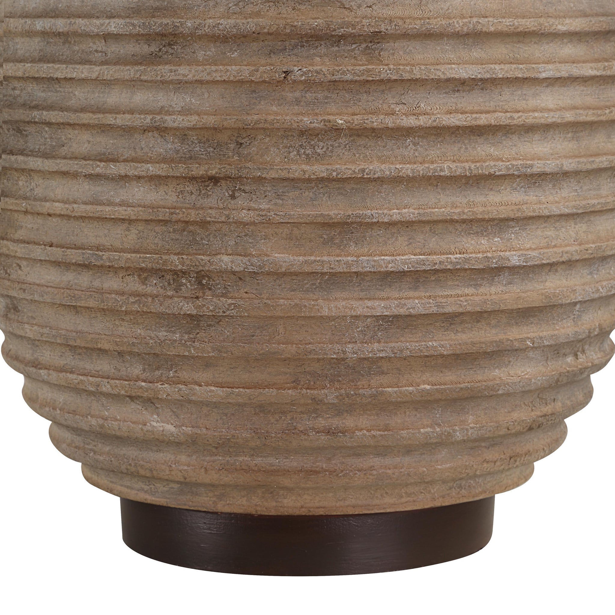 Close-up of Cebada table lamp's beige ceramic base showcasing its ribbed texture.
