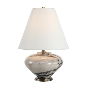 Monumento Table Lamp illuminated, showcasing a white shade and a marble base with gray patterns.