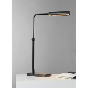 Fabolia Table Lamp in a workspace setting, showcasing its black finish and modern aesthetic.