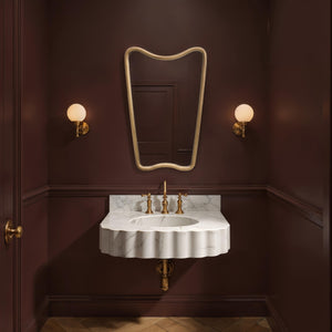 Echoa mirror above a marble sink in a darkly painted bathroom, showcasing elegant decor.
